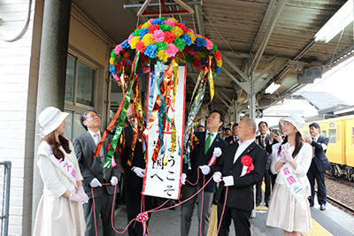 くす玉を割って祝う福田良彦市長ら関係者